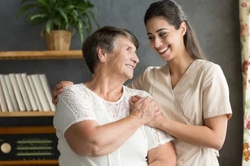 Happy Old Woman With Caregiver