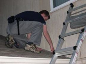 Man Inspecting Roof