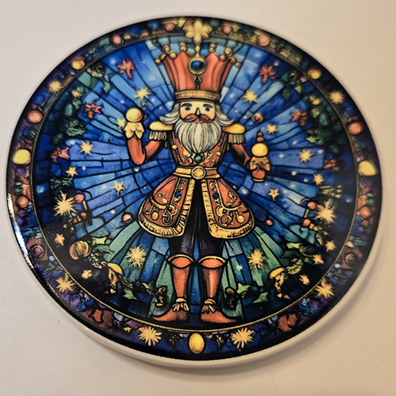 Round ceramic coaster with a stained glass nutcracker design