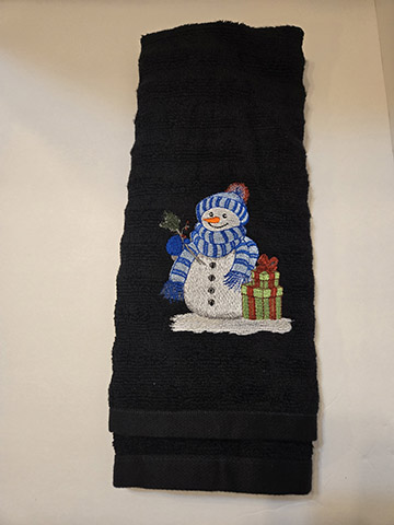 Black hand towel featuring a snowman with gifts design