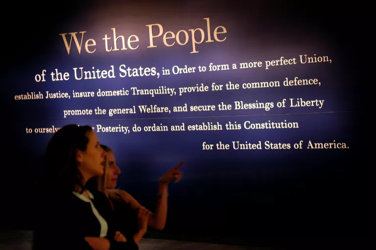 Two women looking at a display of the US Constitution
