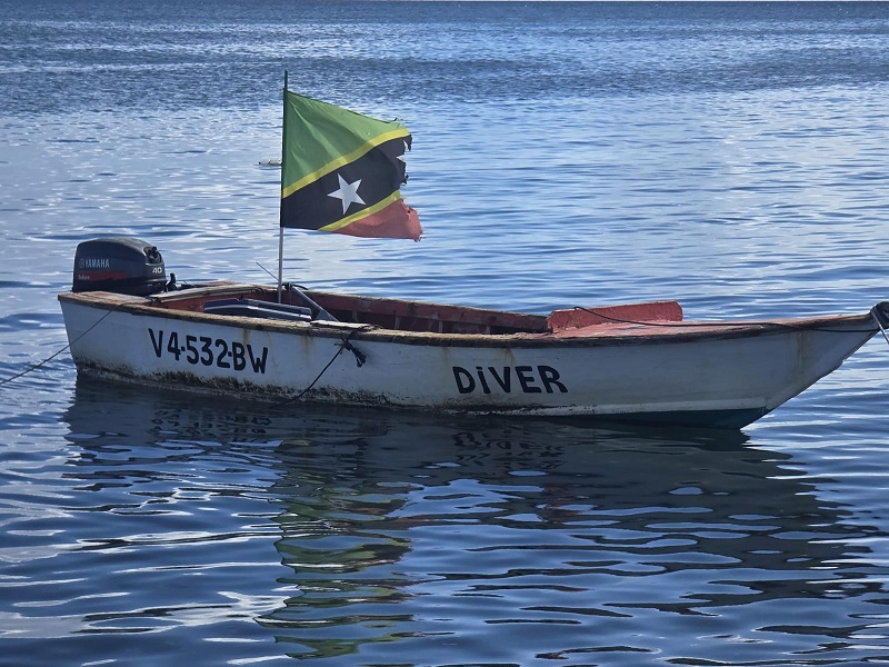 Boat on water with St Kitts & Nevis Flag
