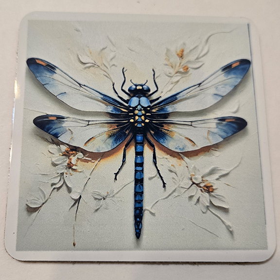 Square metal coaster with a painted dragonfly design