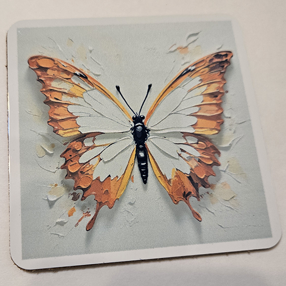 Square metal coaster with a painted butterfly design