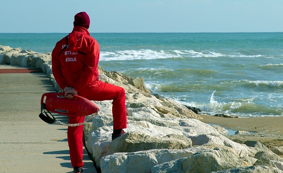 A lifeguard in a red uniform