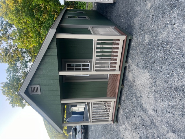 This beautiful 12x24 New England Deluxe Cape Cod Cottage featuring Pequea Green colored wood siding, Clay colored New England trim, and it also featured the Driftwood colored architectural shingles with synthetic underlayment.  This structure was also equipped with classic gable ventilation, 5 30"x36" double hung insulated house windows, 1 3'x75" 9 lite fiberglass house door, a 4x12 porch with composite decking along with vinyl railing, pressure treated floor joists, and skids.