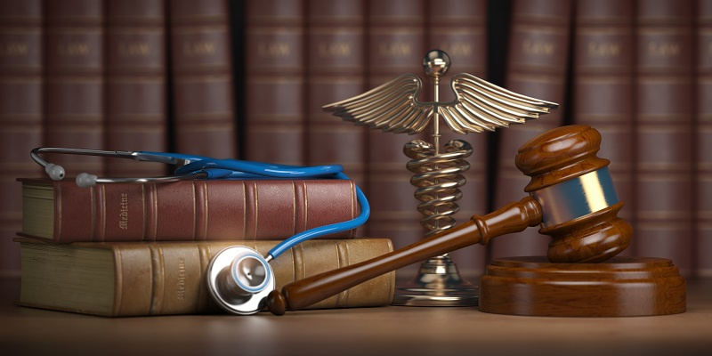 Gavel next to stethoscope and books