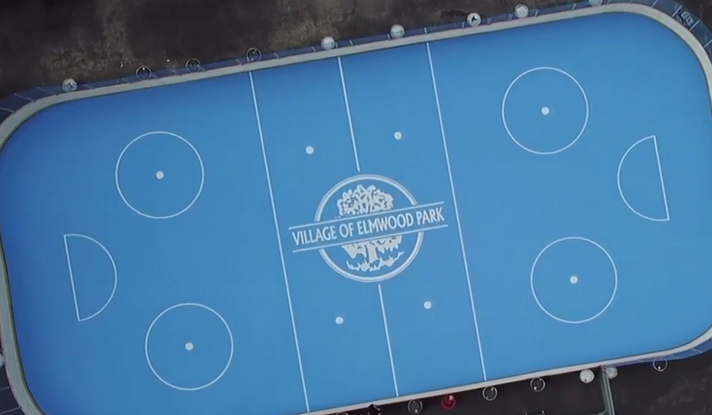 image of village logo painted on hockey rink using paint mask stencils