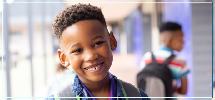 A young male student smiling for a photo