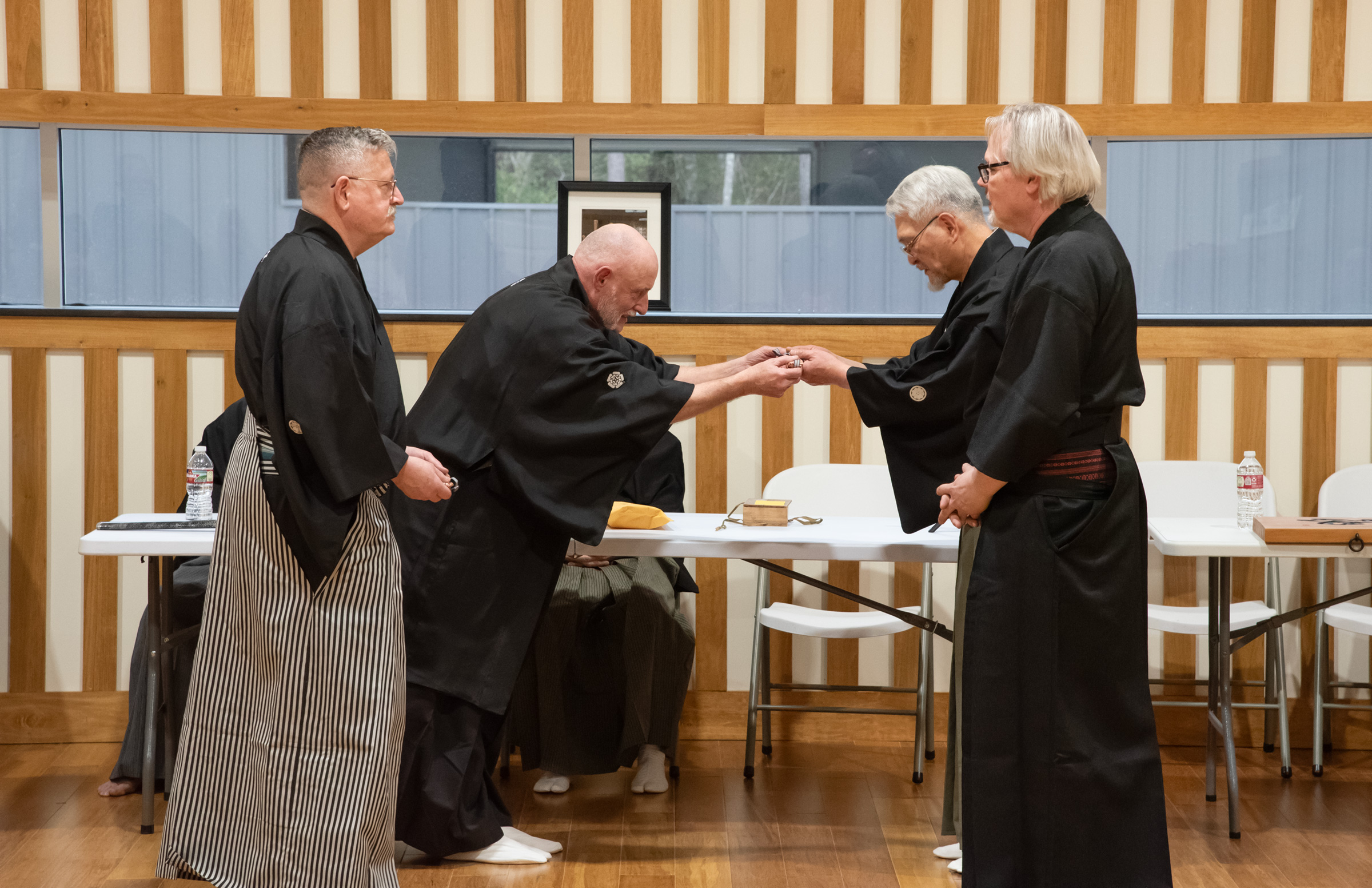 Nomura Sensei receiving an iron tessen from Andrew Delitka Sensei on behalf of the Mizu Hi Kobukai.