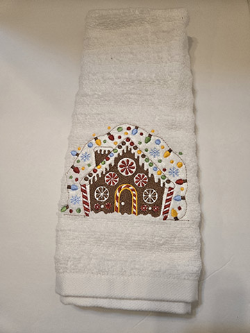 White hand towel featuring a gingerbread house