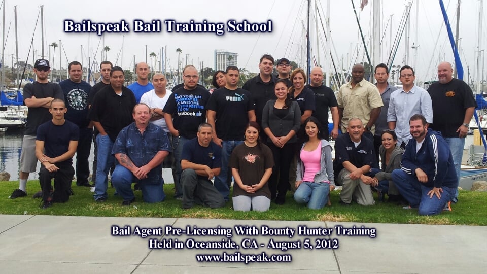 Group photo of Bail Agent Pre-Licensing and Bounty Hunter Training class at Bailspeak Bail Training School in Oceanside, CA, August 2012, with attendees posing outdoors near a marina.