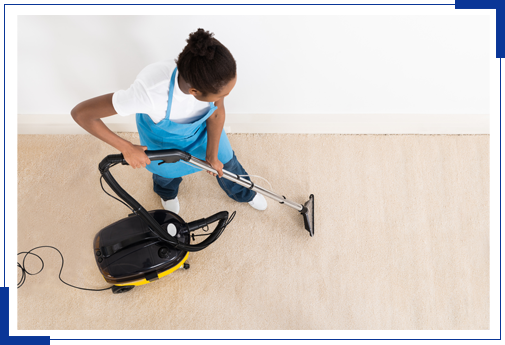 Female Janitor Cleaning Floor With Vacuum Cleaner