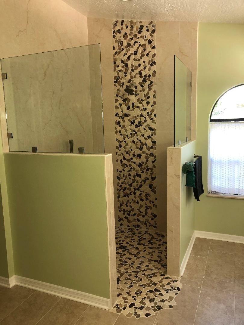 Cascading rock feature with matching shower floor.