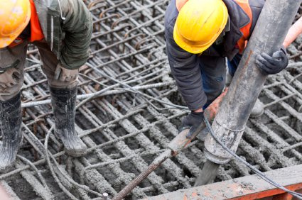 Workers pouring concrete