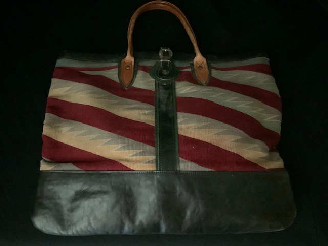PRODUCT PROFILE:
Product No.:  #21311
Description:  Navajo blanket 
and leather suitcase/
briefcase
PRODUCT NARRATIVE:
• handmade in USA 
• lined interior 
• silver buckle
• Size: 18” x 16” 