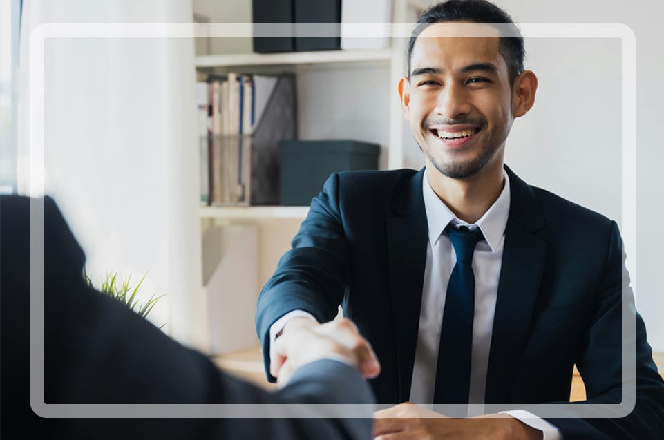 Man shaking the hand of someone off camera