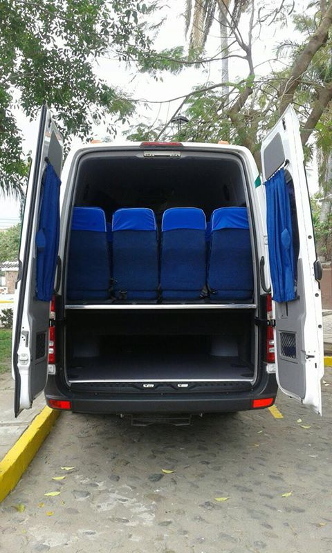 Elderly couple driving a convertible car