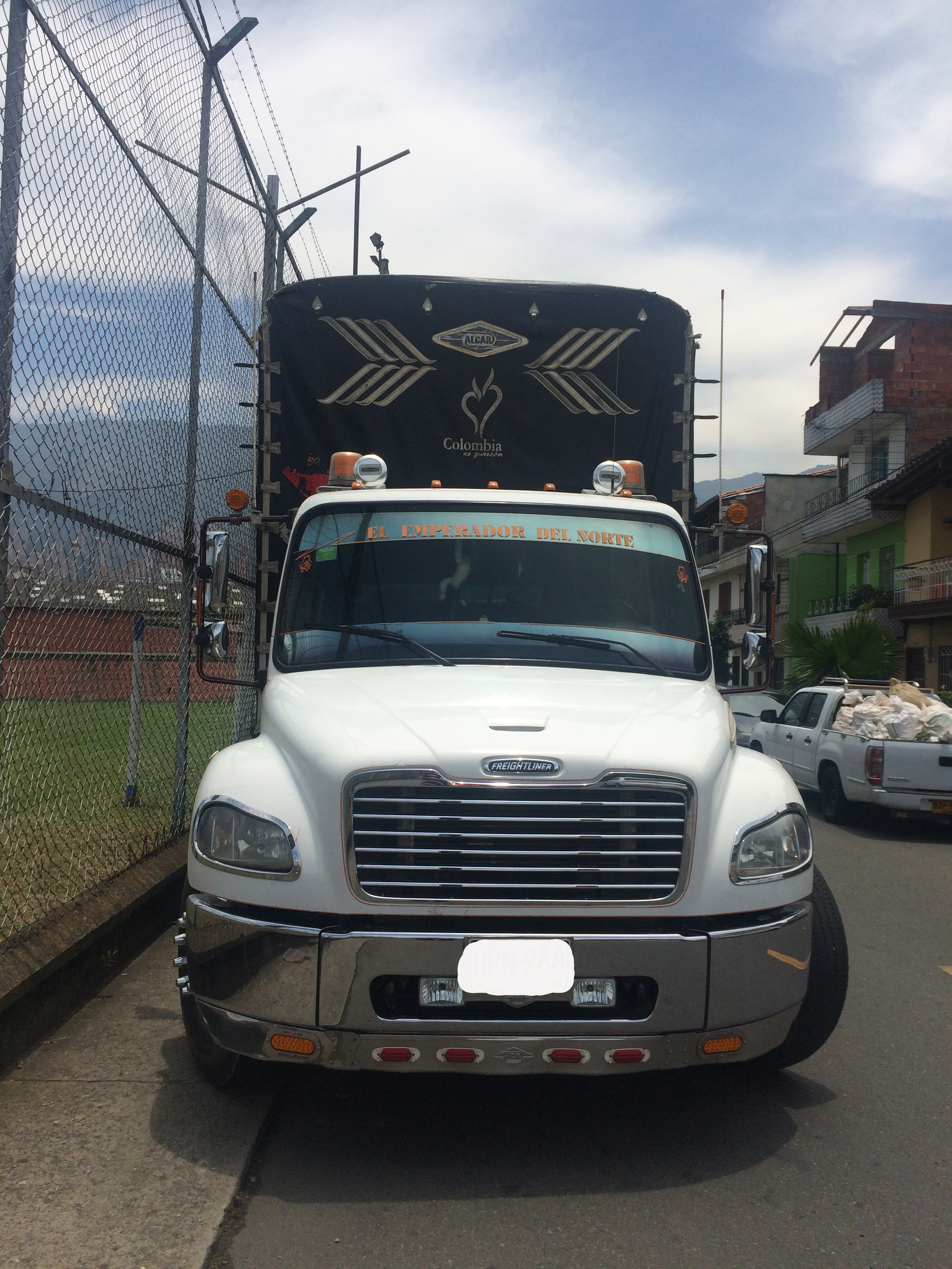 Smiling woman holding two cardboard boxes