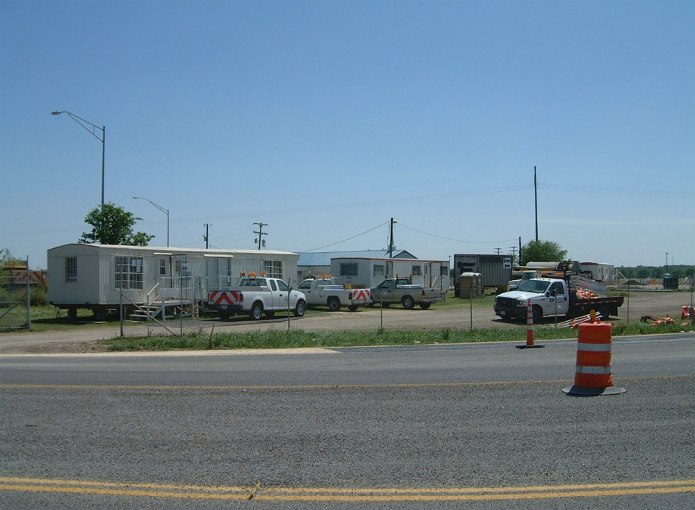 Construction trailers set up near a road.
