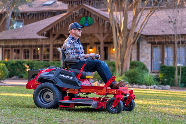 A Man Using a Cordless Lawn Mower
