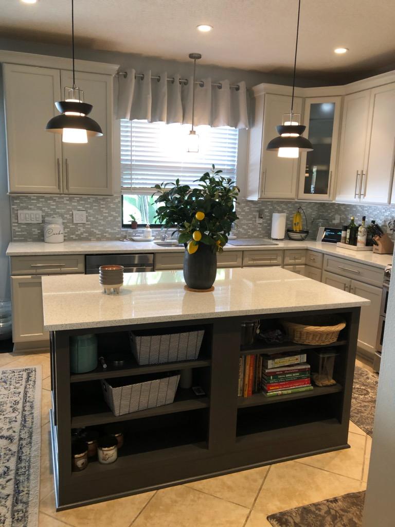 Large kitchen featuring coordinating backsplash and sparkle white Quartz countertops.