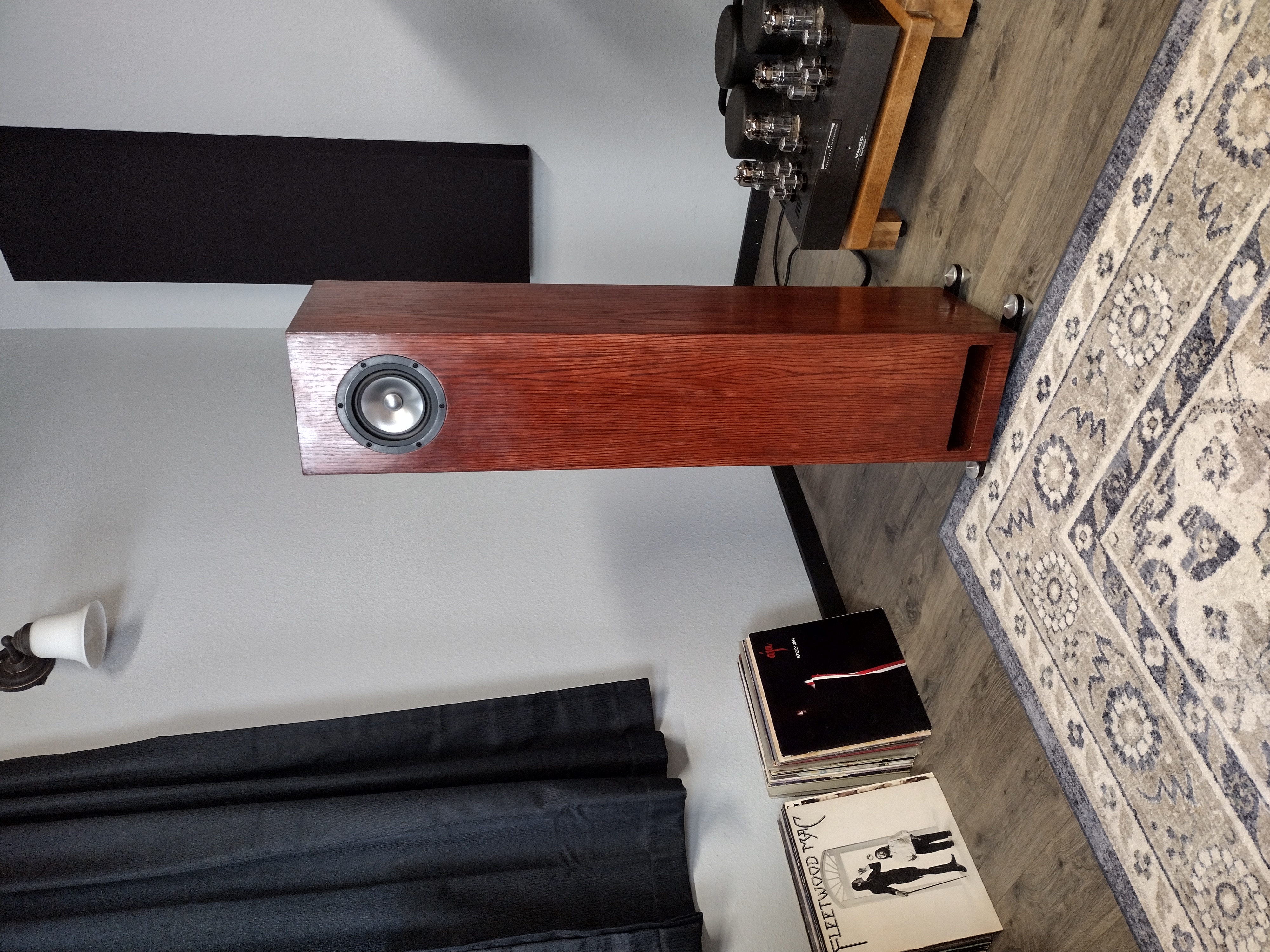 Wooden floor-standing stereo speakers with amplifier in modern minimalist living room