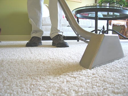 Worker cleaning carpet