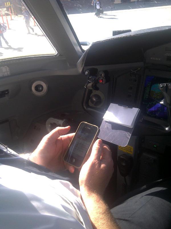 Pilot entering data into phone||||