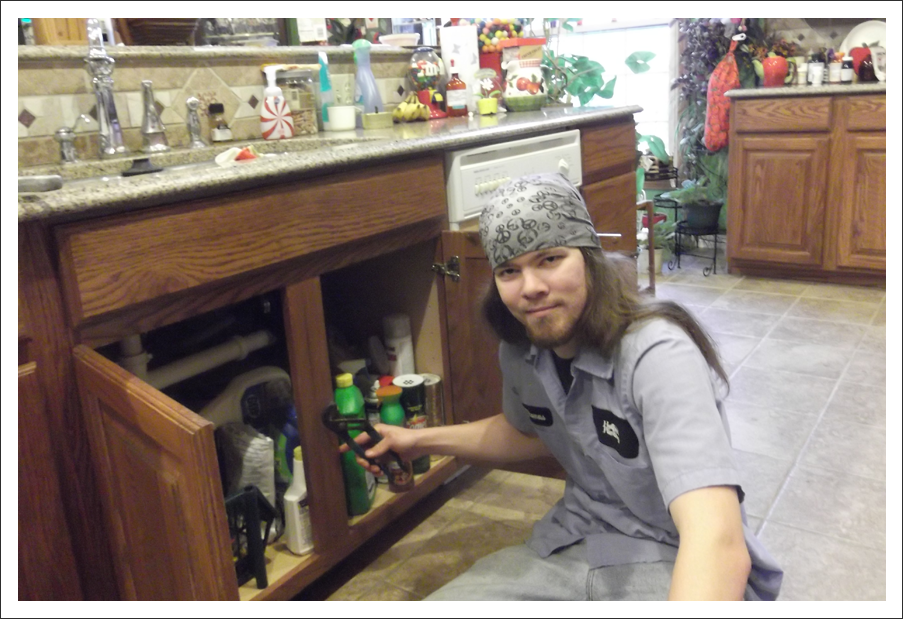 Plumber working under sink||||