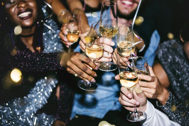 Group of people toasting with champagne glasses at a festive celebration.