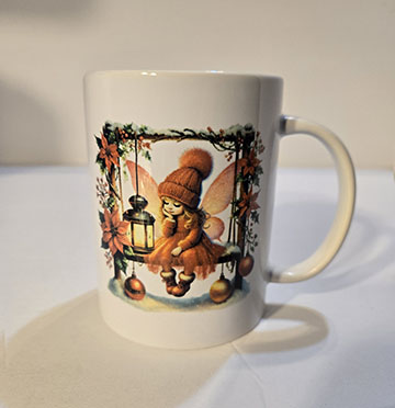 15oz ceramic mug featuring a fairy on a swing design