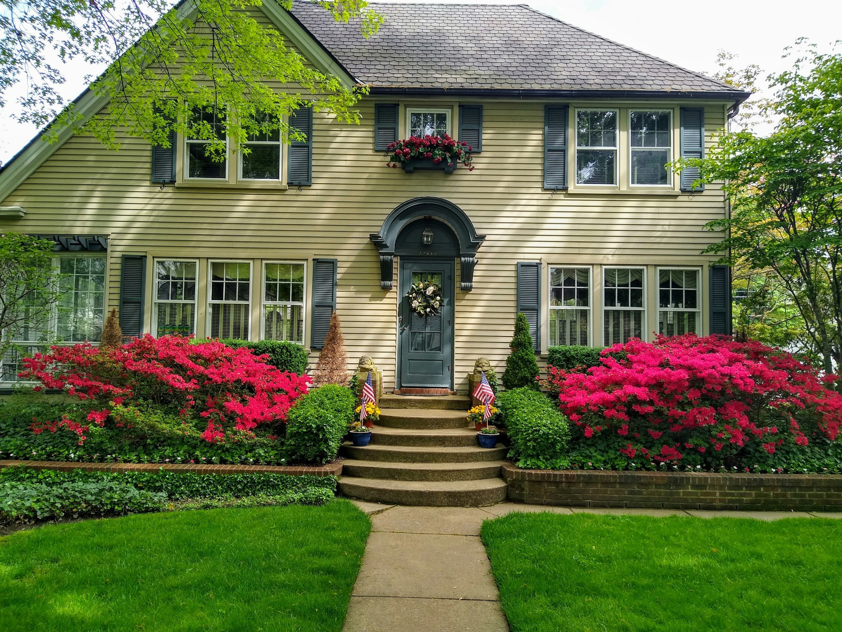 Southern style home with lush yard and flowers