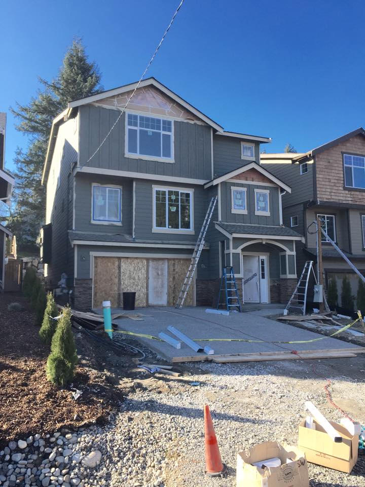 Seattle Home. Here is a new construction home, we installed James Hardie Plank Siding and trims along with stained cedar shingles in the peaks. We also created a custom arches and columns to accent the front entry area of home.