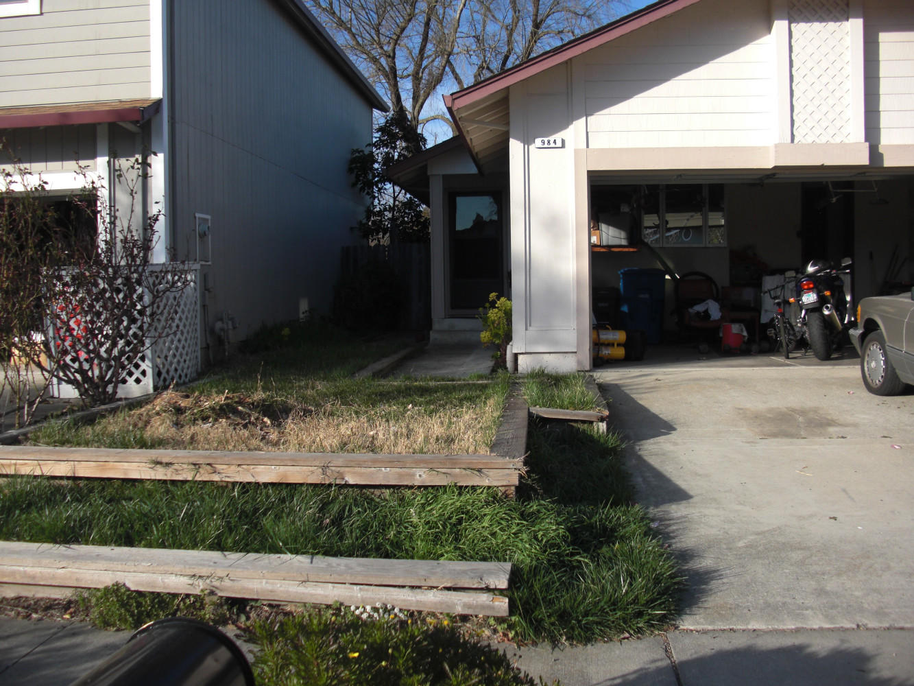 BEFORE - Retaining walls, crabgrass and stump limiting access