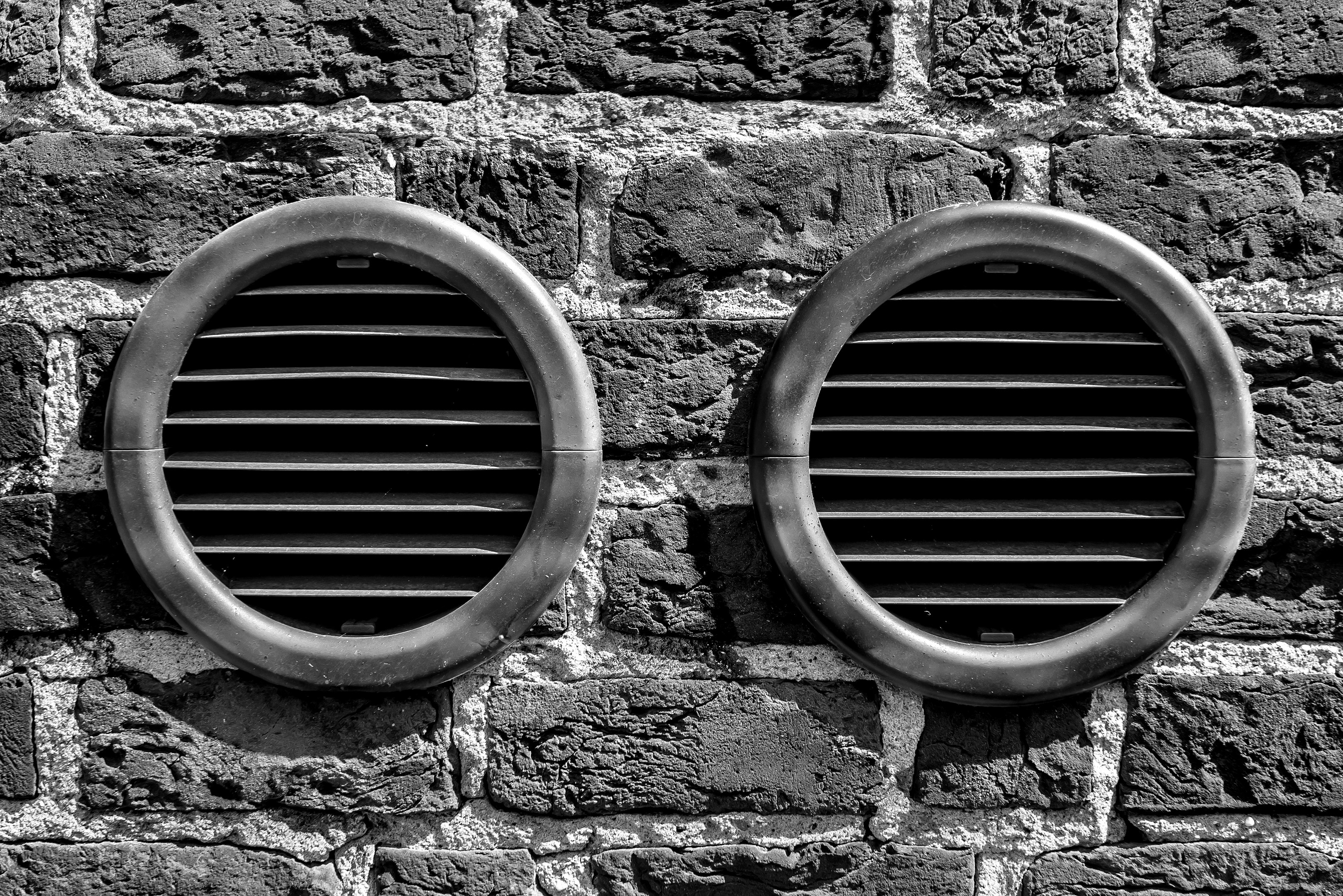 a couple of tires on a brick wall