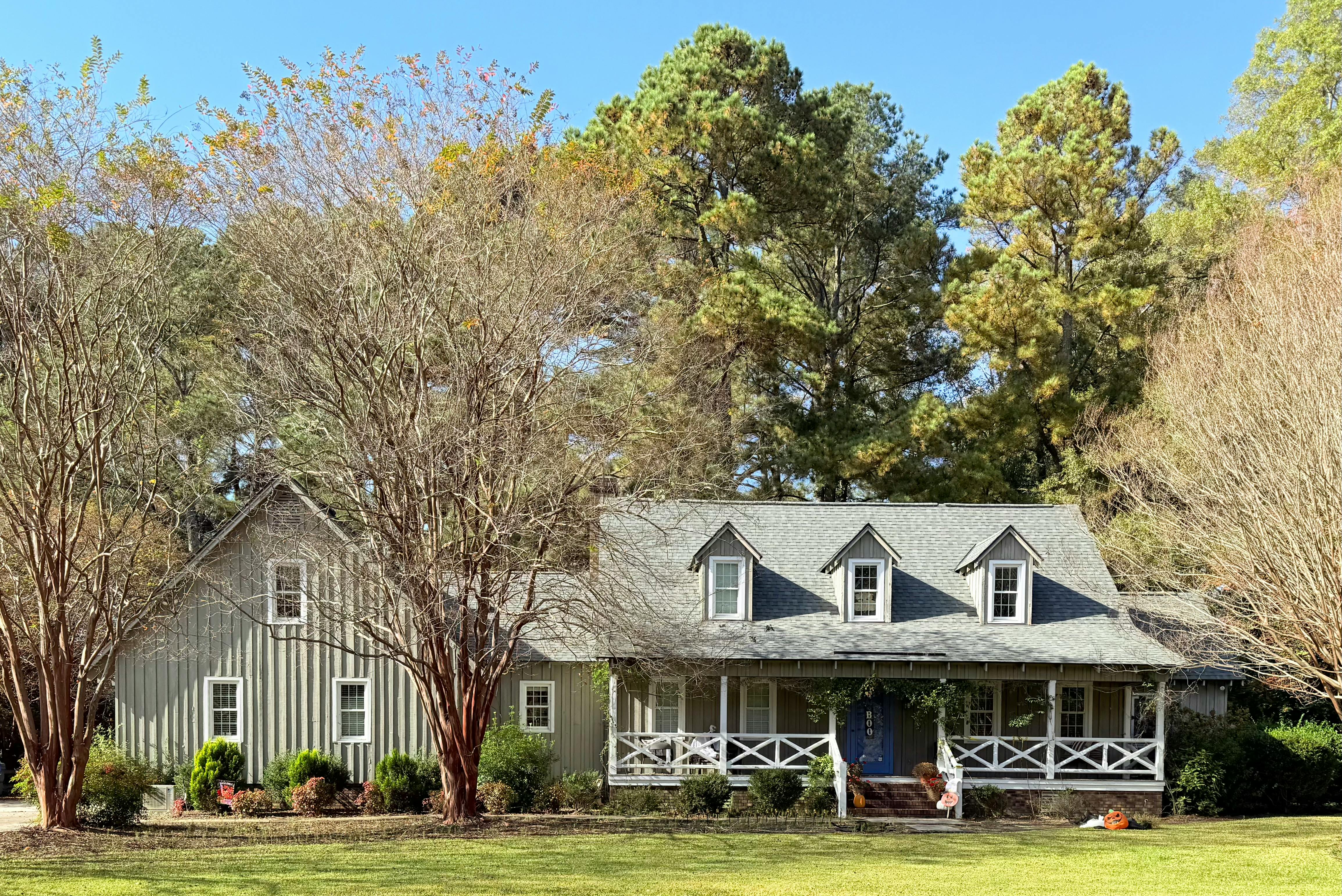 Twos story home in pale green with wide front porch