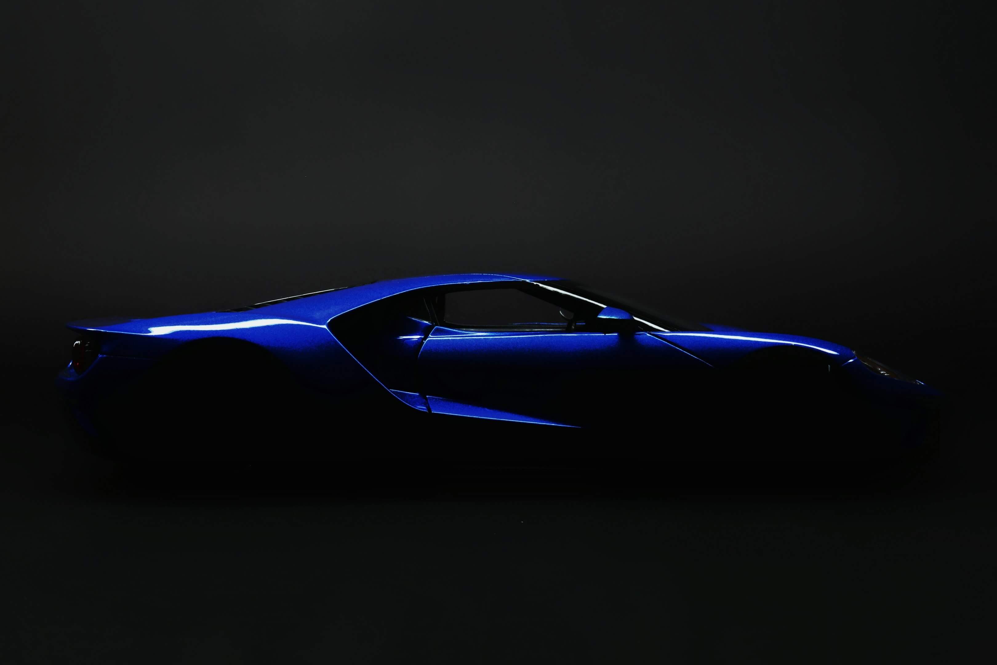 a blue sports car in ominous lighting