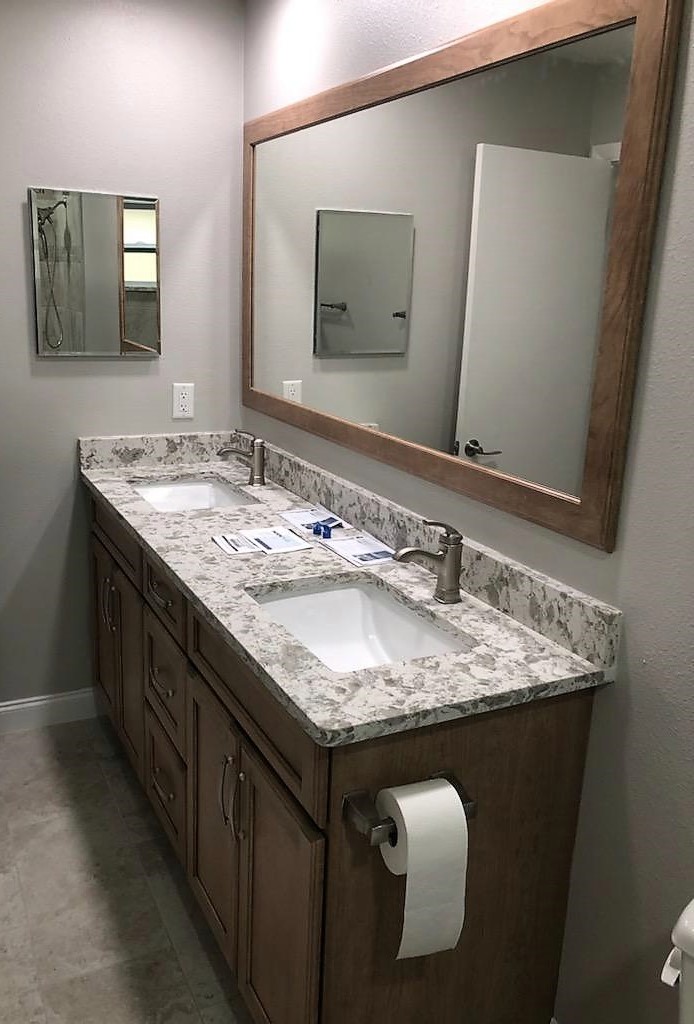Dual sink vanity featuring Quartz countertops and 4" backsplash with matching framed mirror and medicine cabinet.