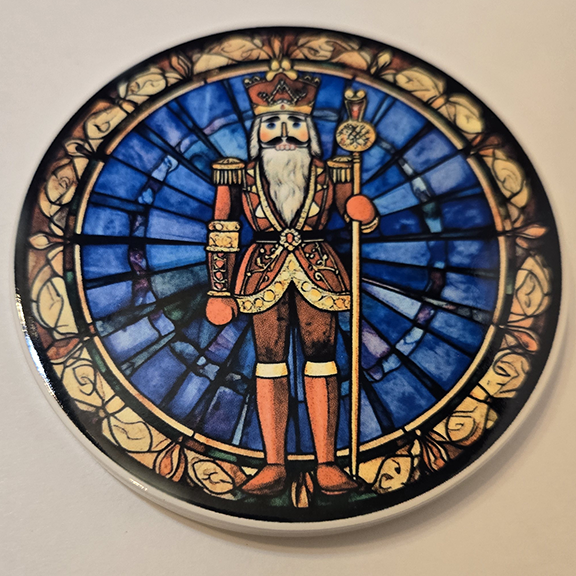 Round ceramic coaster with a stained glass nutcracker design