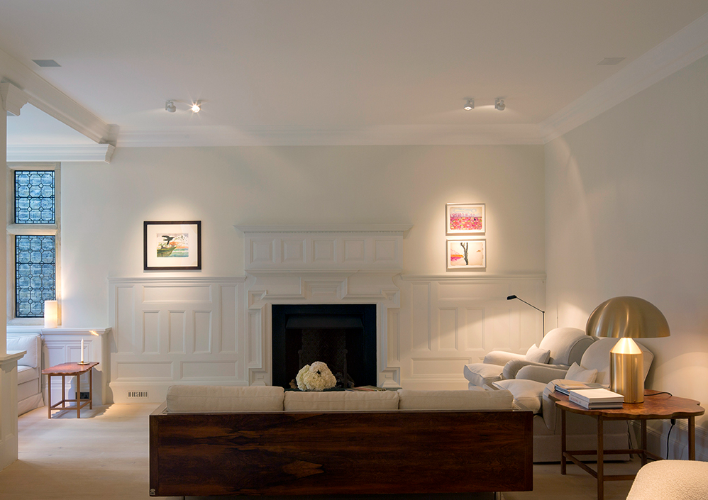 a room with a table chairs and a lamp