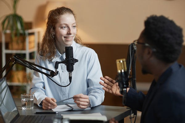 Smiling Woman Listening to Podcast Guest