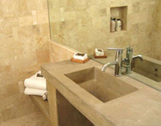 The concrete for this unit was poured in one piece to create a farmhouse-style sink as well as a seat in the shower. 