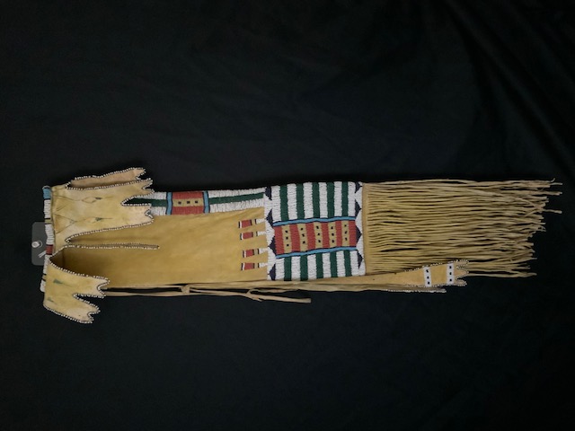 PRODUCT PROFILE :
Product No. : #10041
Description : CHEYENNE TOBACCO BAG
PRODUCT NARRATIVE :
• Four drops off top of bag, and two long side drops
• Yellow ochre along with fringe
• Circa: 1875 Size: length 27"
