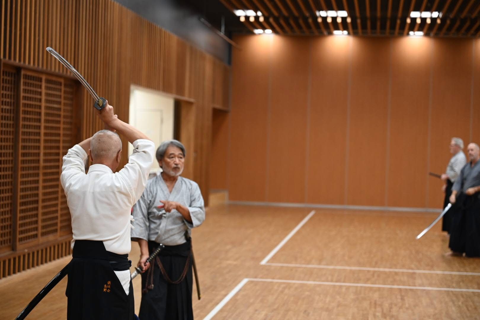 Yoshi assisting Takano Sensei in reviewing kumitachi.