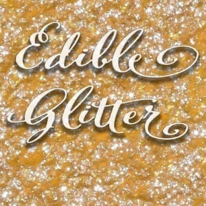 Close-up of gold and silver edible glitter with decorative script text.