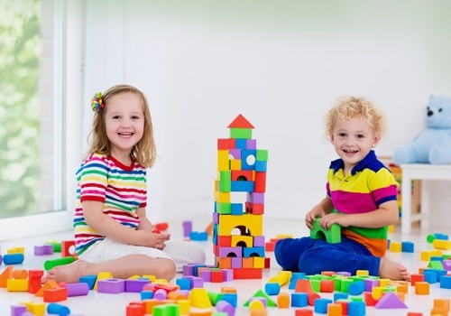 Kids Playing With Colorful Toy Blocks