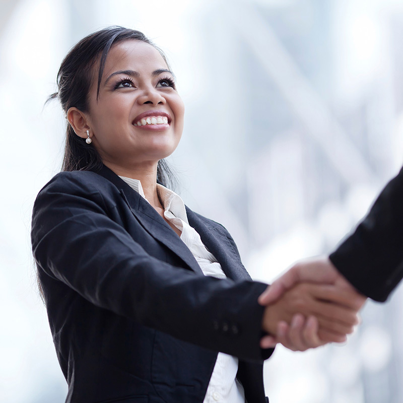 Businesswoman giving a handshake and smiling