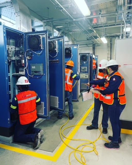 man sitting on chair and writing on desk