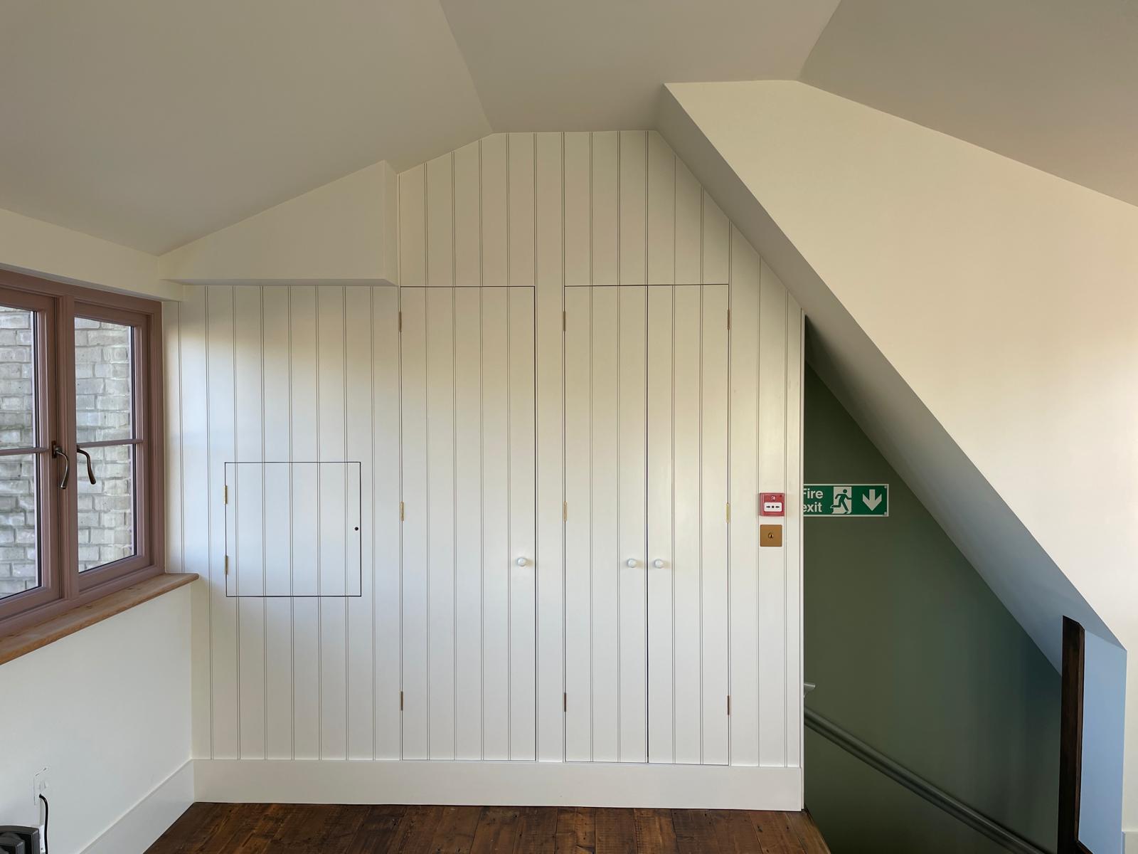 a room with a table chairs and a lamp